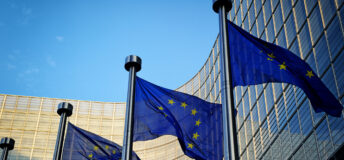 EU flags in front of European Commission building in Brussels