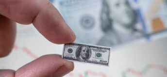 Photo concept of money shrinking in size.